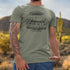 close up of model wearing heather Olive Christmas Vacation shirts featuring Cousin Eddie's RV
