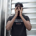 Man wearing the Stealth Wear Invisibility Shirt: Power Low graphic tee. Image showing off side-seamed construction of print quality of the Dodo Tees premium mens t shirts.