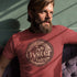 man sitting in booth wearing novelty t shirt with rocky mountain oyster juice logo