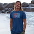 man on beach wearing parody shirt with letsi graphic