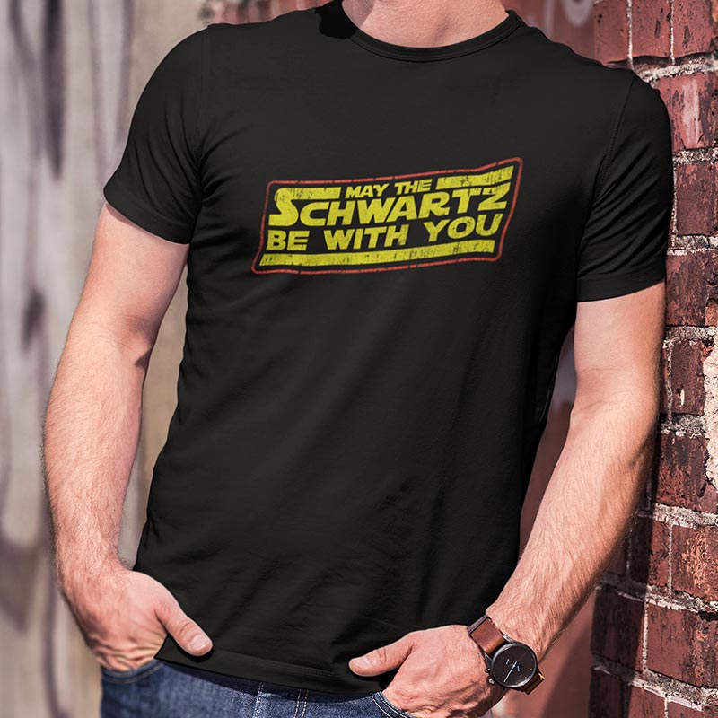 Guy modeling the May the Schwartz be with you retro t shirt sold at the Dodo Tees 80s store.