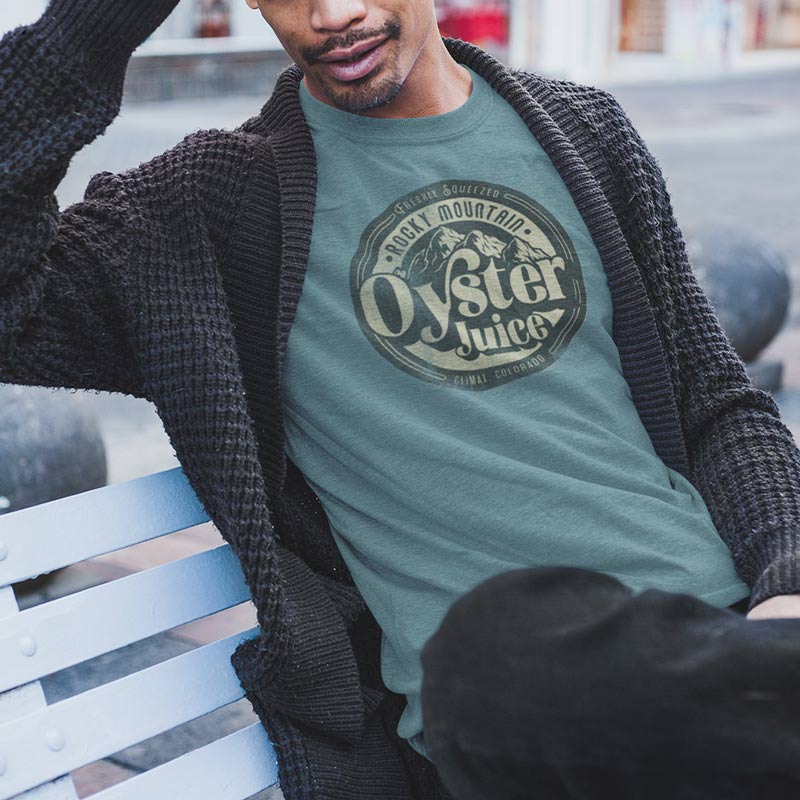 man sitting on bench wearing sarcastic t shirt with rocky mountain oyster juice logo