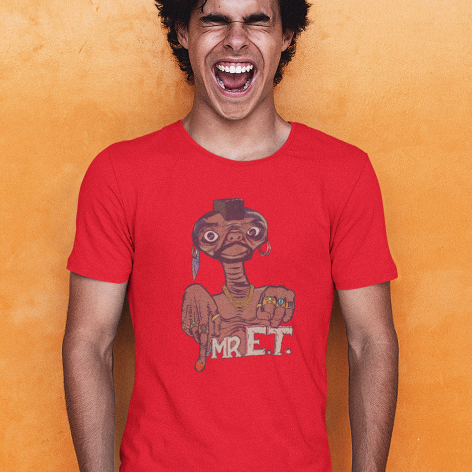 guy wearing a red 80s t shirt featuring Mr. E.T. movie mashup illustration by Dodo Tees. The movie nerd t shirt features ET wearing gold chains and rings.