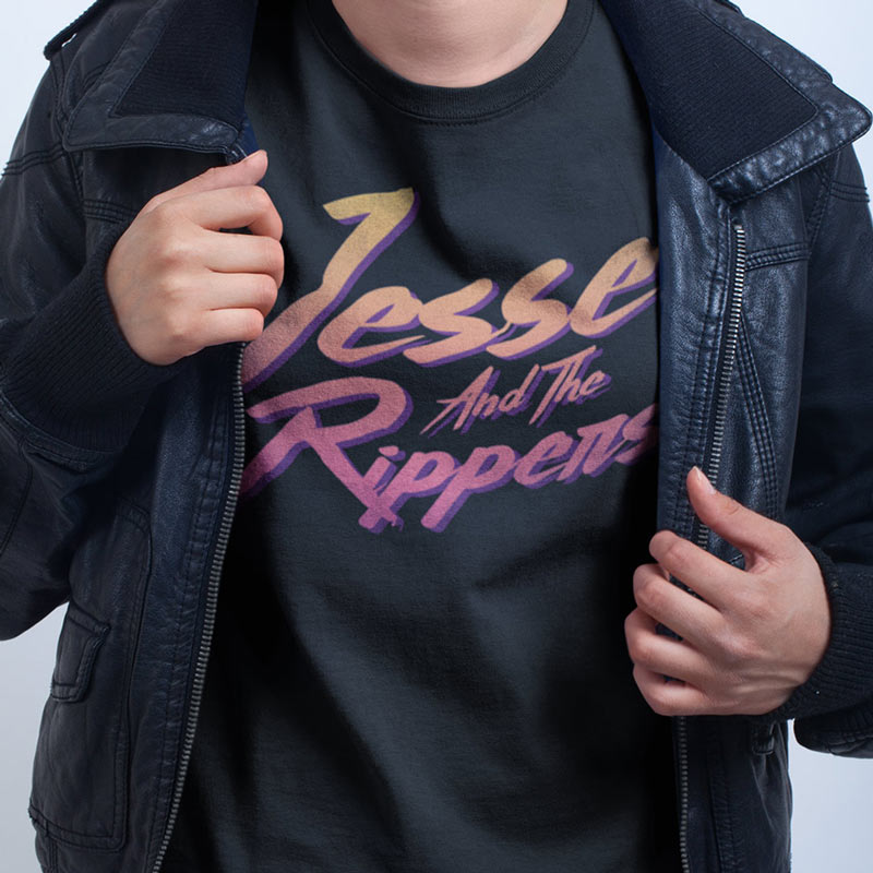 close up of model wearing 90s t shirt with colorful vintage jesse and the rippers logo