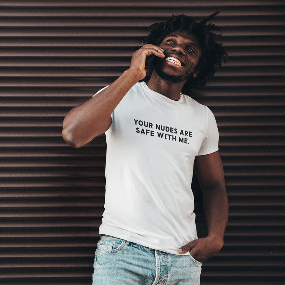 man with smile modeling funny t shirts that read Your Nudes Are Safe With Me. The Offensive T-Shirt has black type on a white shirt.