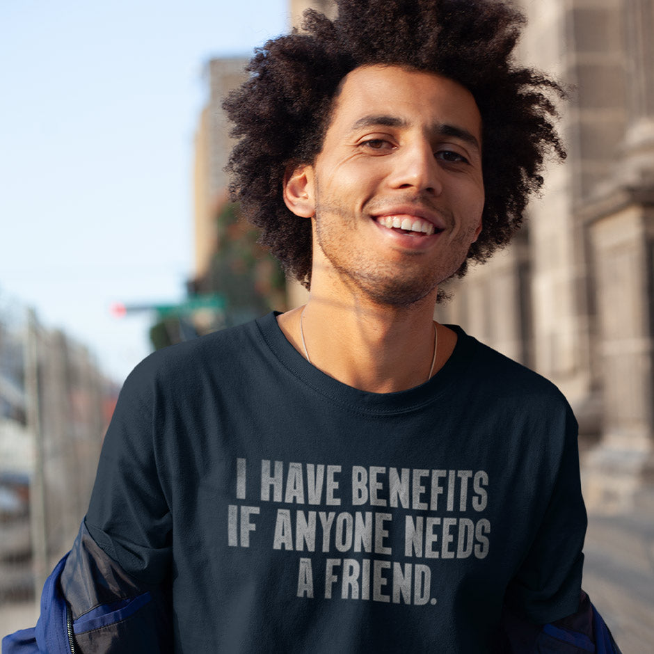 man wearing Inappropriate shirts by Dodo Tees. This navy colored offensive t shirt  reads I have Benefits if Anyone Needs A Friend.