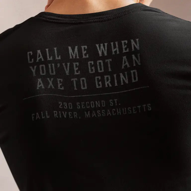 back of Lizzie Borden Killer merch shirt reading "call me when you've got an axe to grind."