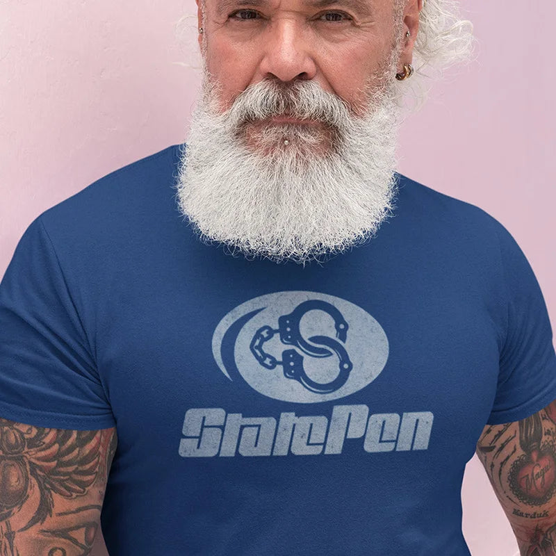 tattooed man wearing manly gift t shirt with state pen logo