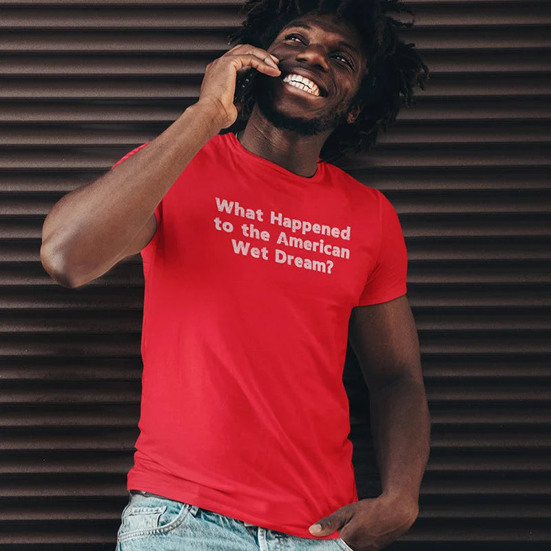 smiling man on phone wearing offensive t shirt that reads what happened to the american wet dream?