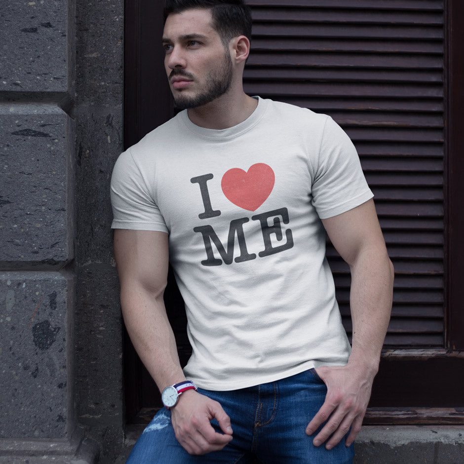 man wearing a sarcastic tee that reads I heart me. The heart is a red icon. The “funny adult shirts are side-seamed for a modern fit.