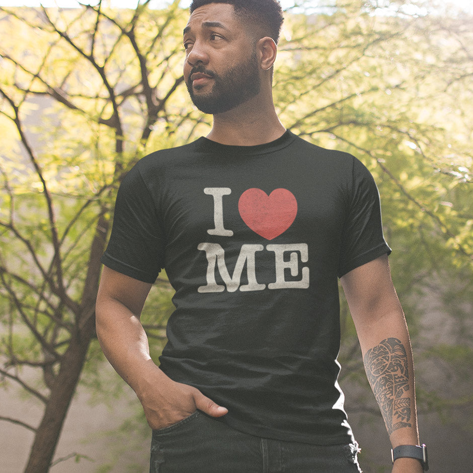 man wearing a sarcastic tee that reads I heart me. The I love me premium funny adult shirts are side-seamed for a flattering fit.