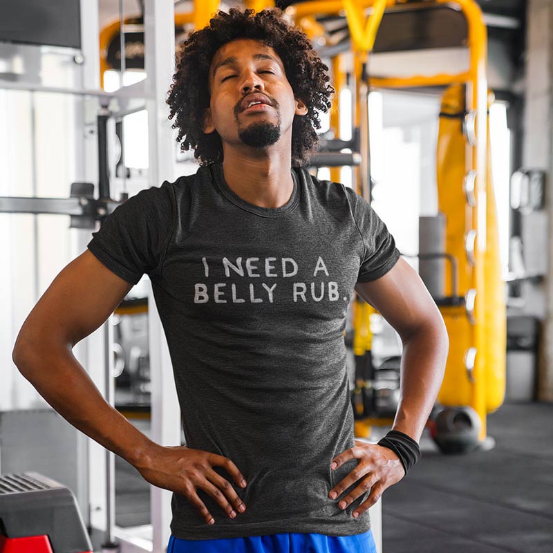 tired man at gym wearing soft t shirt with i need a belly rub text