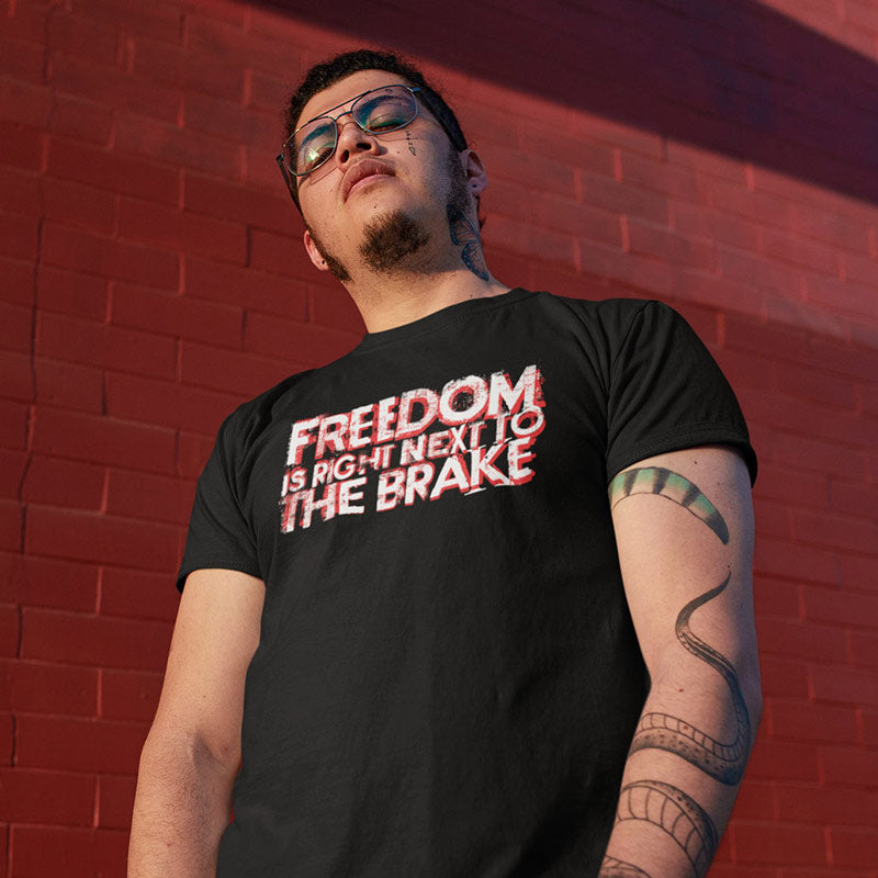 tattooed man wearing automotive apparel with freedom is right next to the brake type t shirt