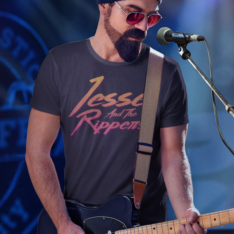 Guy playing guitar wearing a Dodo Tees band shirts featuring the fictional Jesse and Rippers Logo.
