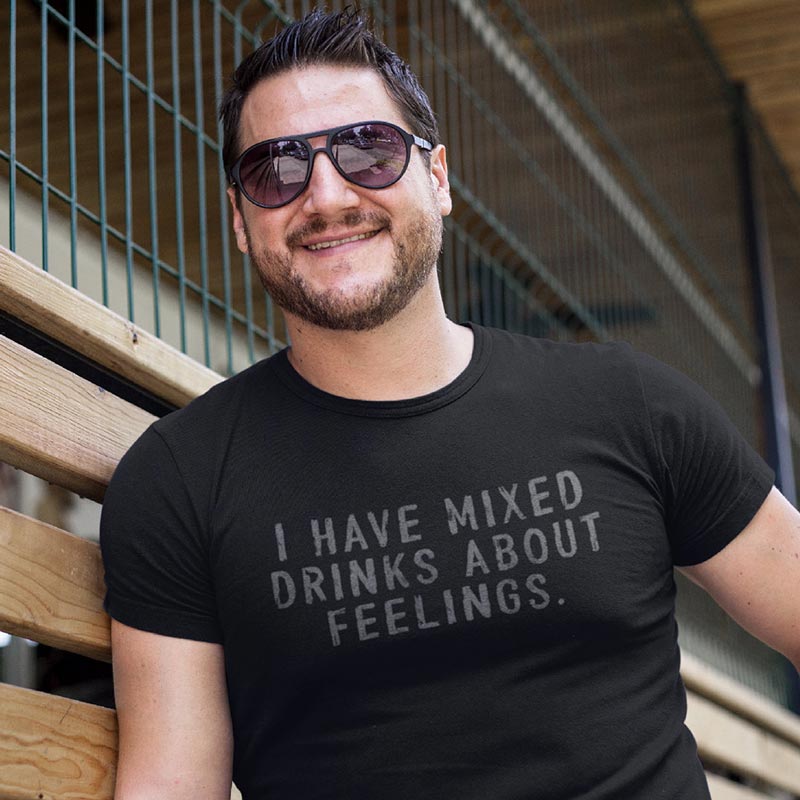 close up of man wearing i have mixed drinks about feelings bar shirt printed on a flattering, fitted black t shirt