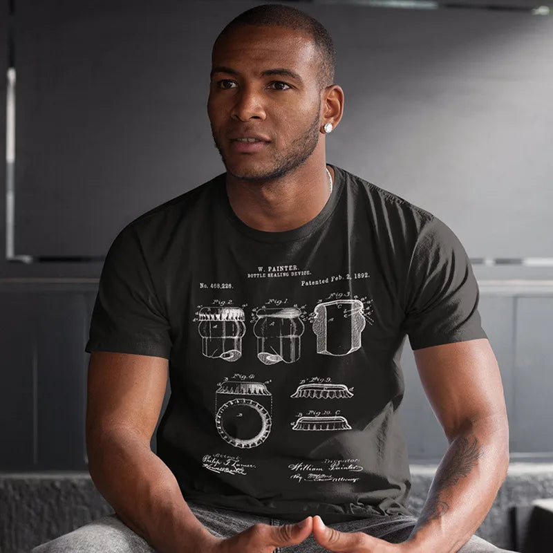 man sitting on bench wearing beer present bottle cap patent t shirt in black