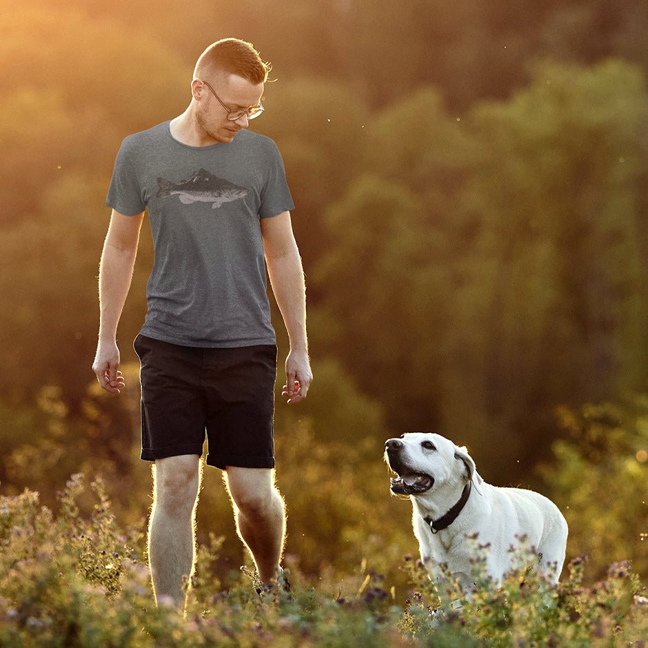 man walking dog on a trail wearing heather slate bass fishing shirt  that he received as a camping gift. The men's outdoor shirts are side-seamed and buttery soft.