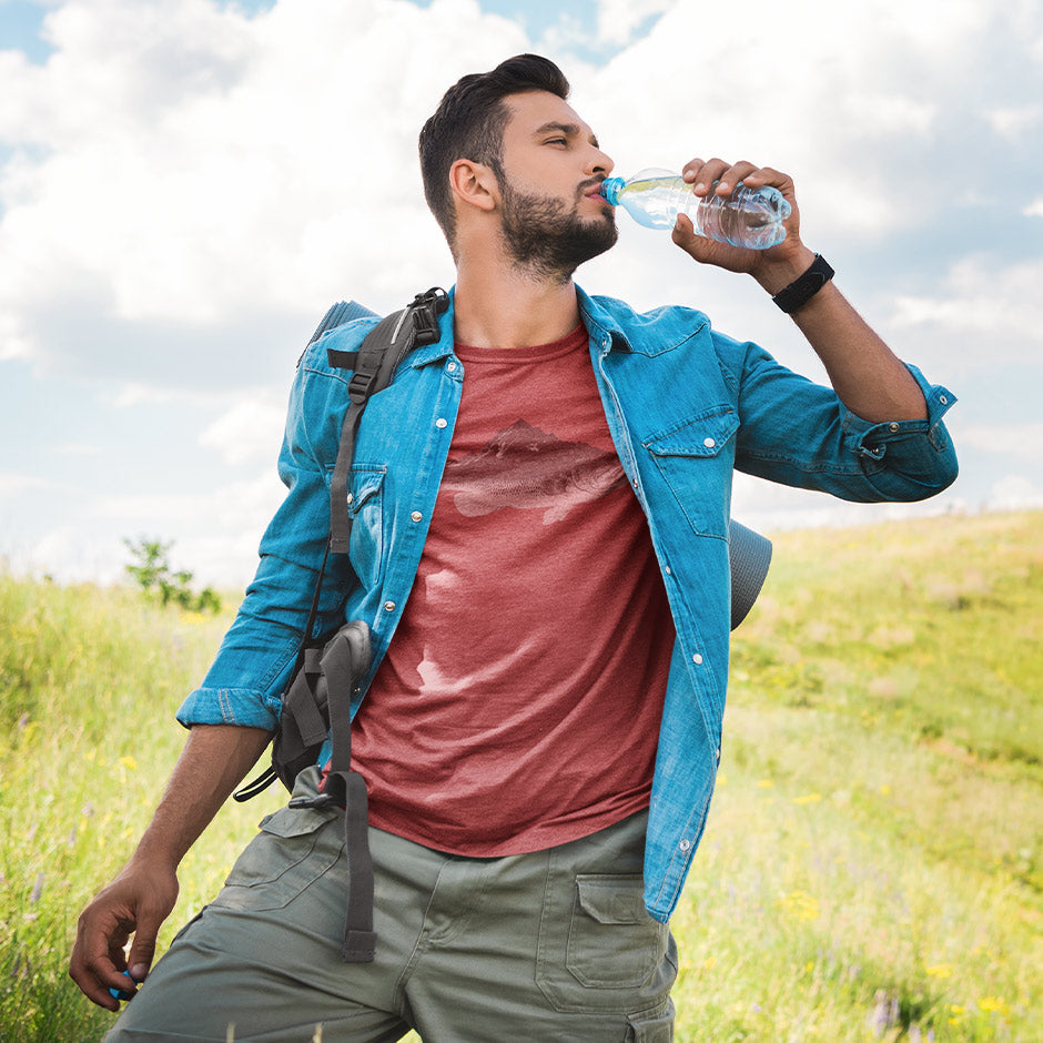 man on trail wearing dad t shirt featuring a bass fish illustration drinking water in the sun. The Fishing Shirts For Men is made from buttery soft heather material.