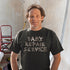 man doing drywall work wearing dad shirt with dads repair service written in duct tape 