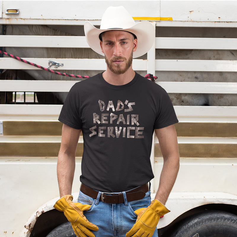 man in cowboy hat wearing black funny dad t shirt with dad's repair service written in duct tape by dodo tees