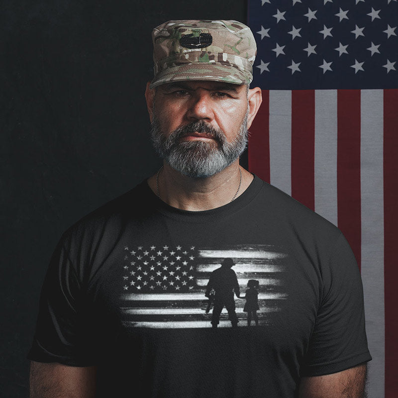 Army soldier wearing a fourth of july shirt by Dodo Tees featuring a soldier holding hands with his daughter