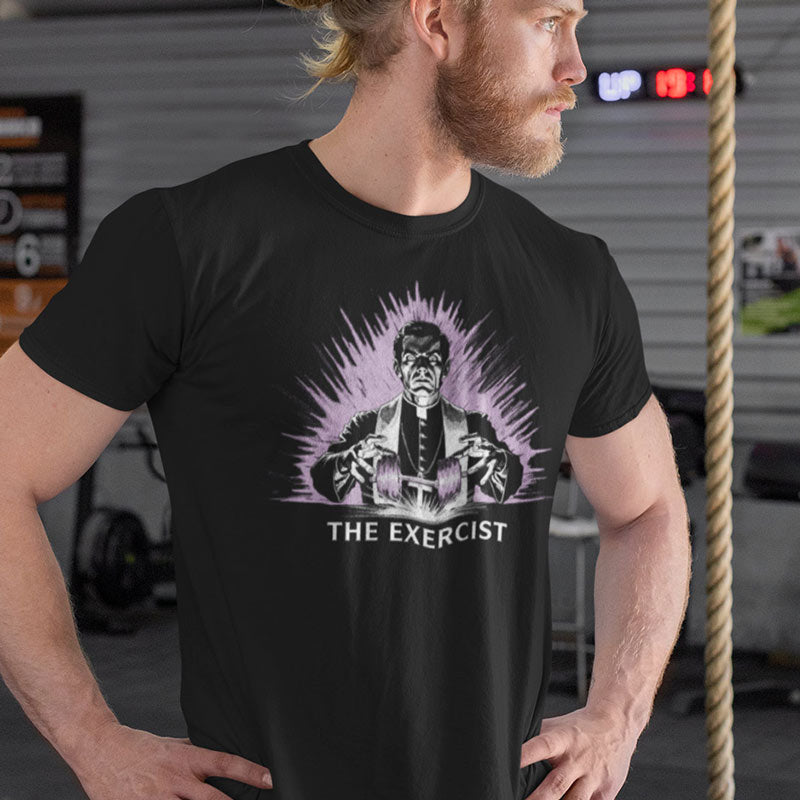 Man modeling funny exercise t shirts by Dodo Tees. The Funny Gym Apparel has a Design of a priest levitating a barbell.