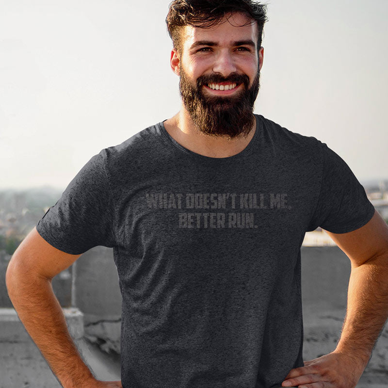 stretching man wearing funny gym apparel with what doesnt kill me better run typography