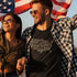 man holding american flag wearing funny patriotic shirt with sexy american city names graphic