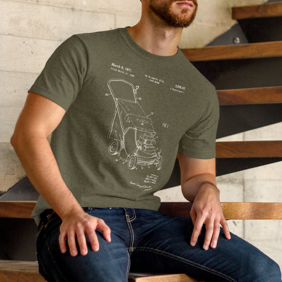 Man sitting on steps wearing a Dodo Tees gardening tshirt featuring a push lawn mower patent. The Lawn Mower Shirt is side-seamed for a great fit.