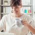 woman at desk holding her gift for animal lovers you're my rock otter mug