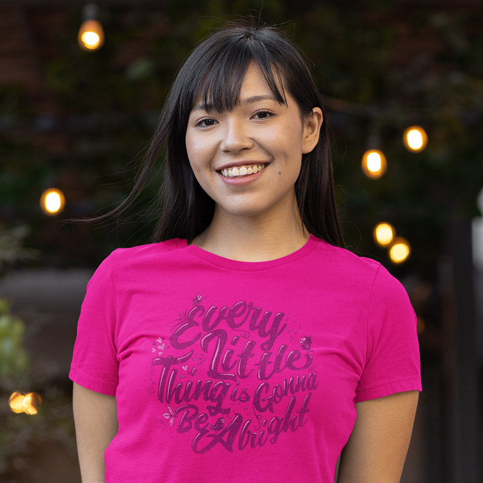 smiling woman outside wearing gifts for women every little thing is gonna be alright fitted pink t shirt