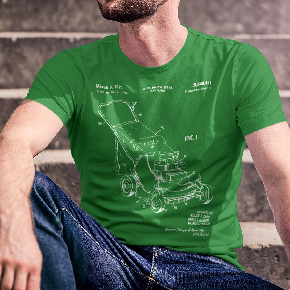 man wearing a green t shirt featuring a push lawn mower patent from 1971. Manly Shirts by Dodo Tees. 