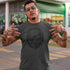 tattooed man outside wearing grunge skull shirt in charcoal by dodo tees