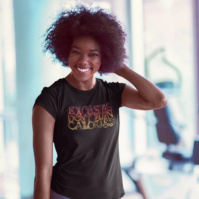 smiling woman wearing gym wear that says excuses don't burn calories in fun typography