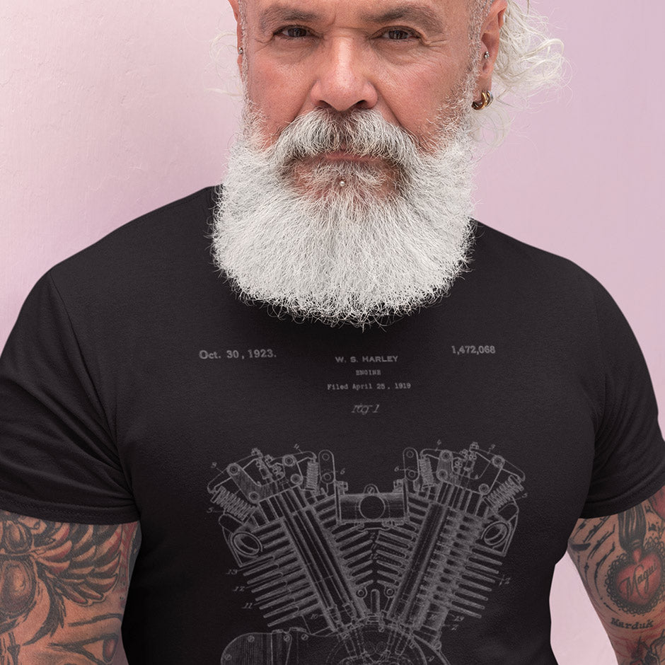 tattooed biker wearing a Dodo Tees Harley shirt for men featuring the 1923 Harley Model 23 JS engine patent. The Motorcycle Shirts are side-seamed for a great fit.