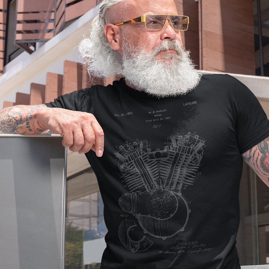 tattooed biker wearing a Dodo Tees Harley shirt for men featuring the 1923 Harley Model 23 JS engine patent. the Biker Apparel is buttery soft and printed in Detroit Michigan.