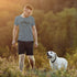 man hiking with dog wearing hiking shirt with geometric mountain illustration