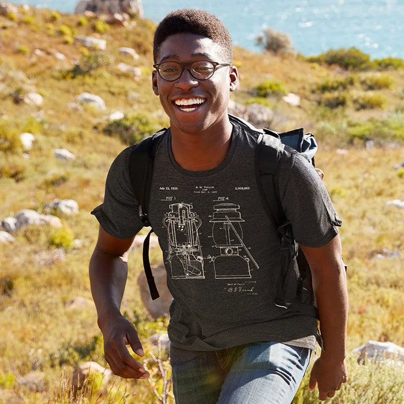 smiling man wearing hiking shirt with lantern patent