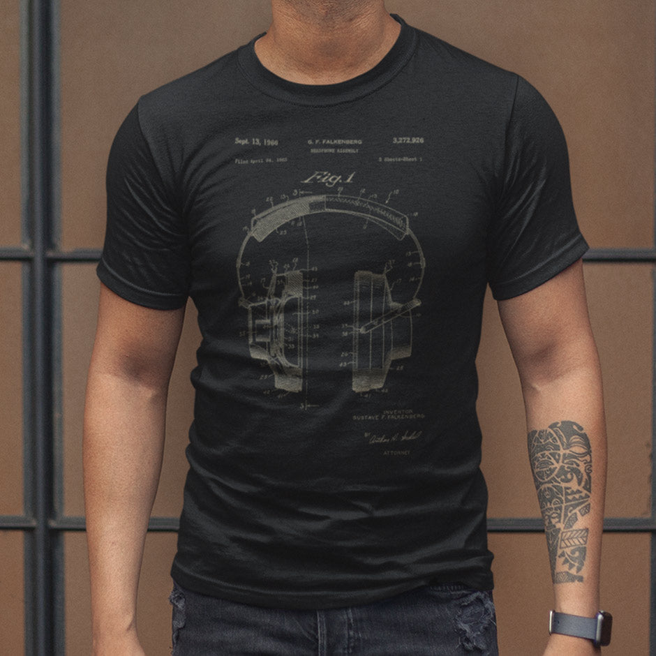 man wearing a hip-hop t shirt featuring 1966 patent for hifi headphones. The Music Themed Shirts are side-seamed to contour perfectly to your form. Our buttery soft Our Music T Shirts feature graphics printed with premium inks.