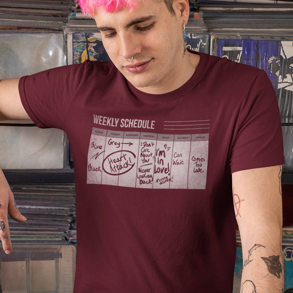 punk man in record store wearing lyric t shirt with friday i'm in love calendar printed on the front. The calendar shown on the rock music shirts has hand written notes on it that correspond to the song lyrics