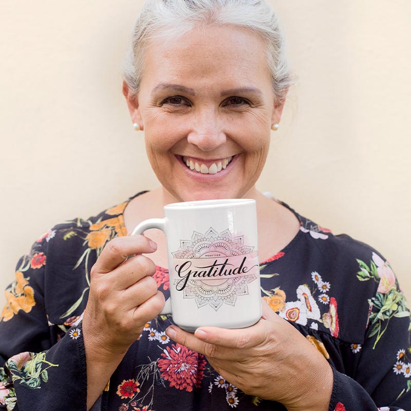 smiling woman holding meditation gifts practice gratitude mug by dodo tees