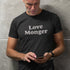 man wearing a mens funny shirt with the word Love Monger on the front. The charcoal Valentines Day Shirt is made from heather fabric.