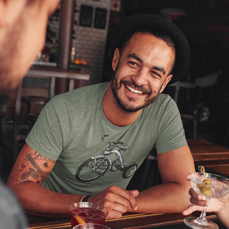 man in bar wearing mens retro t shirt with tricycle graphic