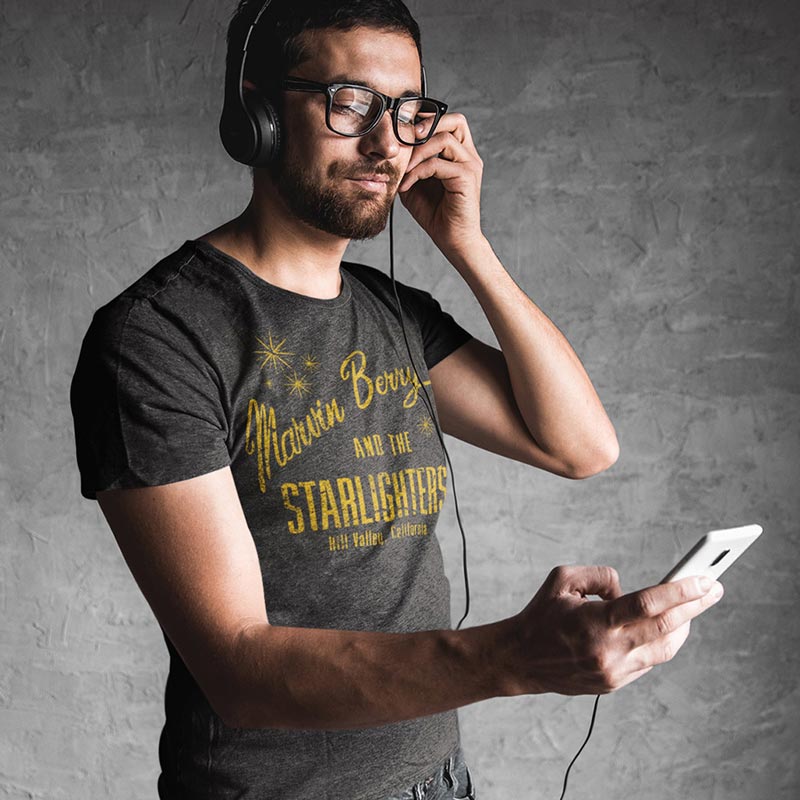 man listening to music wearing movie t shirt with marvin berry and the starlighters band logo