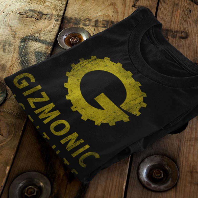 close up view of folded movie t shirt with gizmonic institute distressed logo by dodo tees