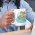 man at desk holding nerd mug with shcrodinger's shipping logo