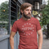 bearded man standing outside wearing patriotic shirt with 1776 graphic. The 1776 4th of July Shirt” 13 stars. Dodo Tees are high-quality graphic tees. The 4th of July shirts are preshrunk, and utilize premium inks and materials.