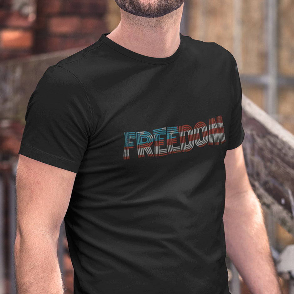 guy wearing a black patriotic t shirt reading Freedom. The Patriotic T Shirts For Men are side-seamed for a modern fit.