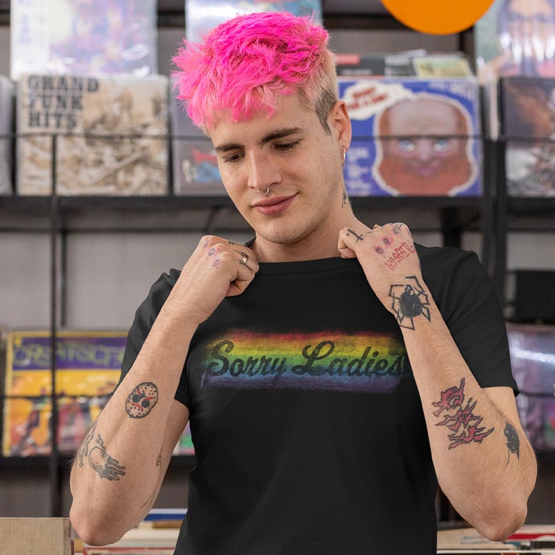 man in record store wearing pride shirt with rainbow sorry ladies design