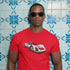 man in sunglasses wearing racing shirt with 906 carrara 6 graphic